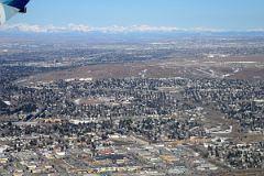 02D Calgary Is Spread Out With The Rocky Mountains In The Distance From The Air In Winter.jpg